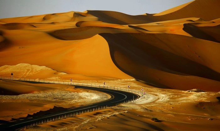 A road winding through desert dunes